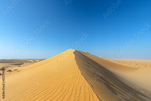 Photograph of sand dunes in the desert with clear blue sky background