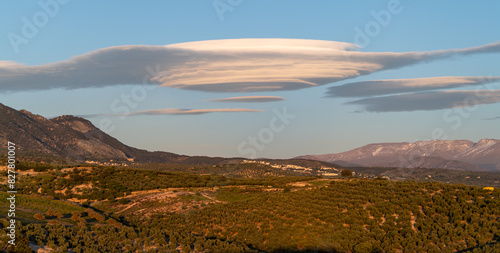 Huge lenticular clouds over hills of olive trees in Andalucia (Spain) at sunset