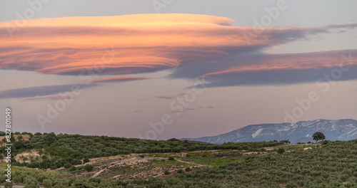 Huge lenticular clouds over hills of olive trees in Andalucia (Spain) at sunset