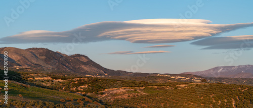 Huge lenticular clouds over hills of olive trees in Andalucia (Spain) at sunset