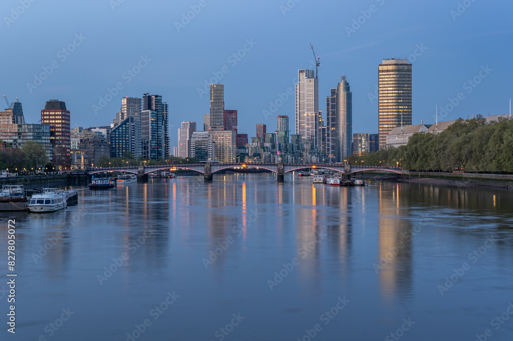 Westminster Palace and Vauxhall skyscrapers over River Thames in the blue hour, London, United Kingdom