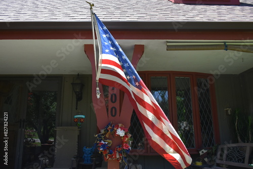 American Flag on the Front Porch of a House photo