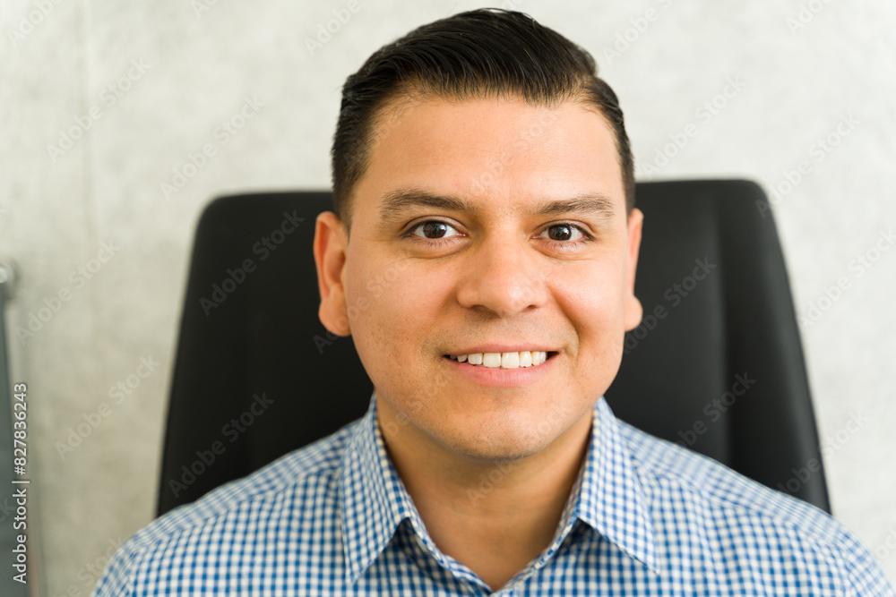 Friendly Latin peatient ready to get his eyes and sight checked in an medical clinic Friendly Latin peatient ready to get his eyes and sight checked in an medical clinic