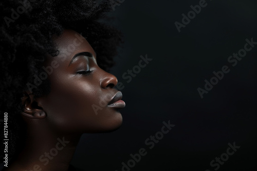 A close up of a black woman's face with her eyes closed looking to a side