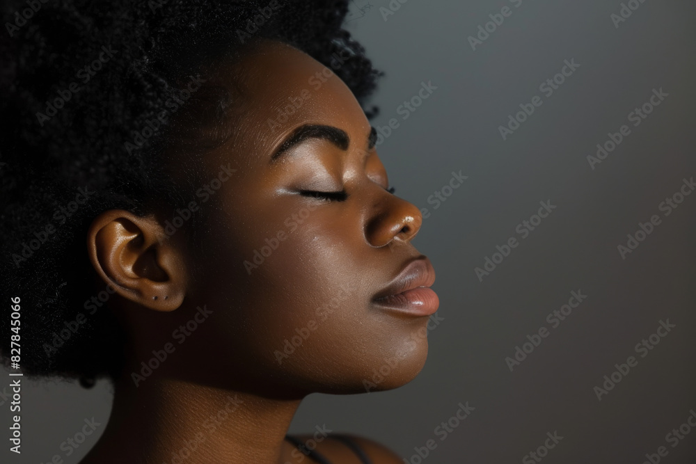 A close up of a black woman's face with her eyes closed looking to a side A close up of a black woman's face with her eyes closed looking to a side