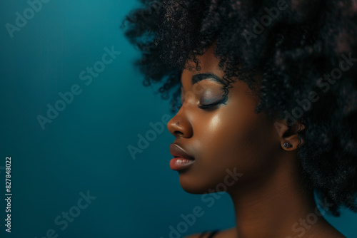 A close up of a black woman's face with her eyes closed looking to a side