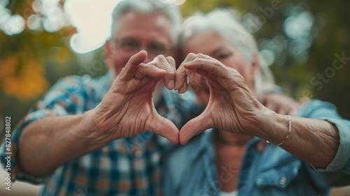 Elderly Couple Forming Heart Gesture