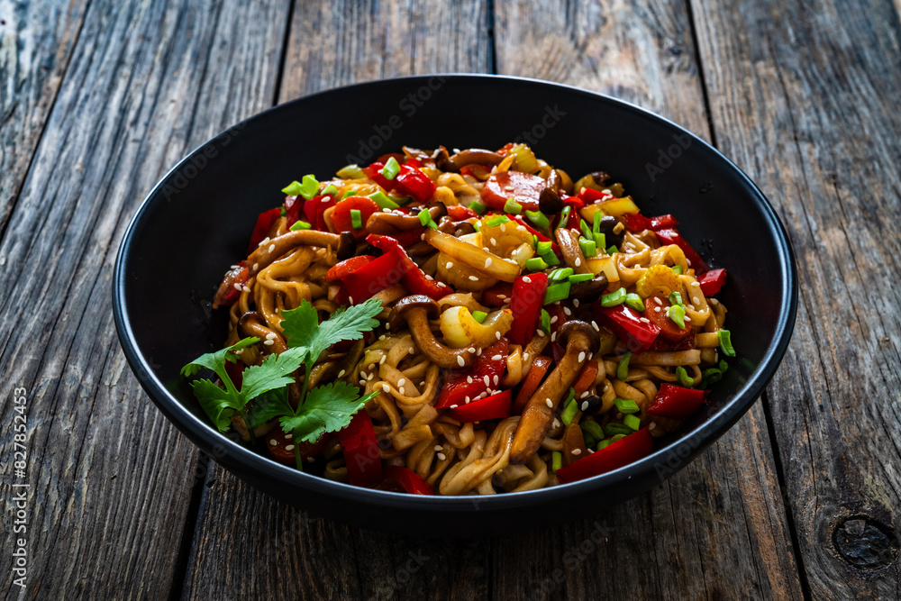 Asian style stir fried vegetables and noodles on wooden table
Asian style stir fried vegetables and noodles on wooden table