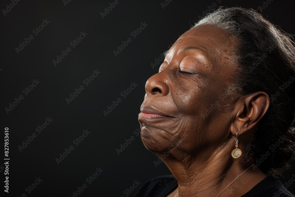 A close up of a black woman's face with her eyes closed looking to a side A close up of a black woman's face with her eyes closed looking to a side
