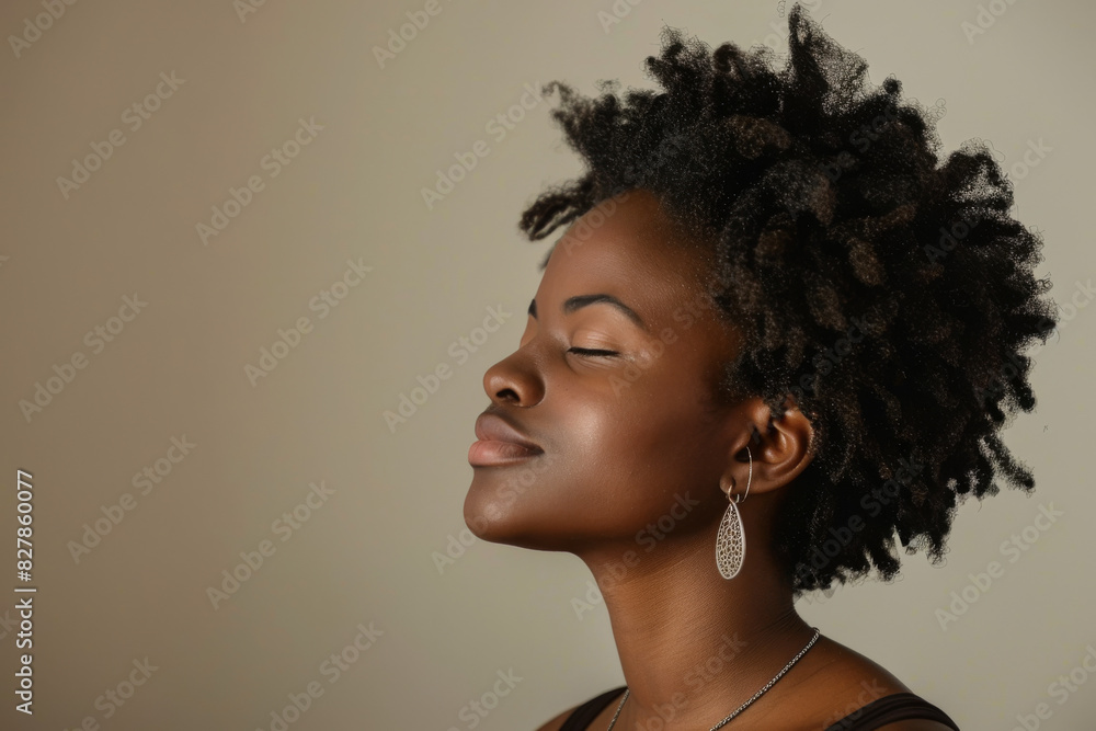 A close up of a black woman's face with her eyes closed looking to a side A close up of a black woman's face with her eyes closed looking to a side