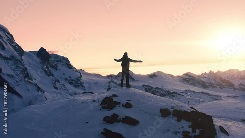 Fear Challenge Success Achievement Epic Aerial Of Successful Climber Raising Arms Success Standing Up On Mountain Top At Sunset Winter Mountains Alps Healthy Lifestyle Business Success Concept photo