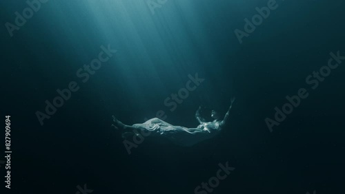 Silhouette Of Depressed Young Woman Sinking In Dark Deep Ocean Underwater Storm Black Water Loneliness Violence Psychological Disorders PTSD Sexual Physical Emotional Abuse Mental Illnes Disease 4K