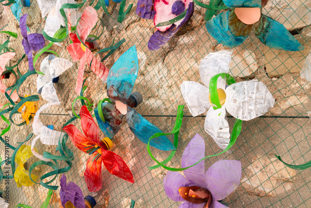 Fototapeta premium Flower wall decoration with plastic bottles made from plastic waste. Concept: Waste recycling and environmental protection