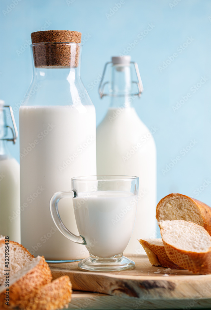 Dairy products, bread, milk bottles on light blue background. Jewish holiday Shavuot concept Dairy products, bread, milk bottles on light blue background. Jewish holiday Shavuot concept