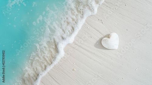 Fototapeta Naklejka Na Ścianę i Meble -   heart seashell in the white sand with the turquoise sea and soft waves in background - travel concept