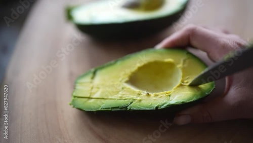 Close-up footage of a chef skillfully slicing an avocado pear with a sharp knife.