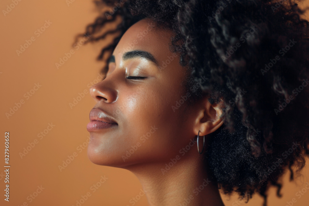 A close up of a black woman's face with her eyes closed looking to a side A close up of a black woman's face with her eyes closed looking to a side