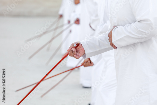 Traditional Emirati Al Ayalah male dance, UAE heritage, hands in frame