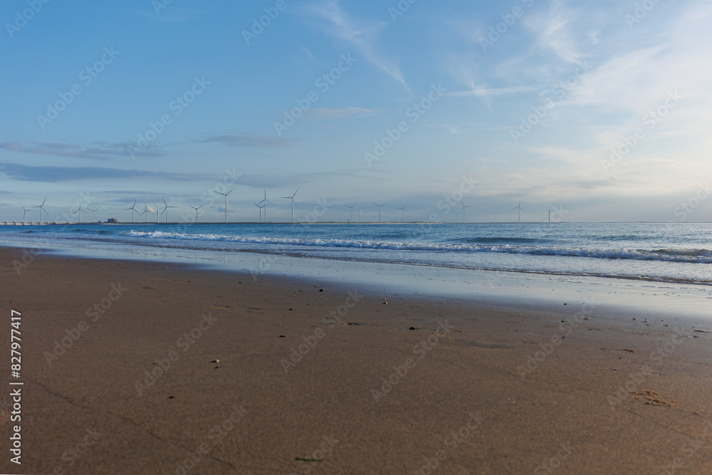 Holland’s Coastline: Sandy Beach and Sea Wind Turbines Holland’s Coastline: Sandy Beach and Sea Wind Turbines
