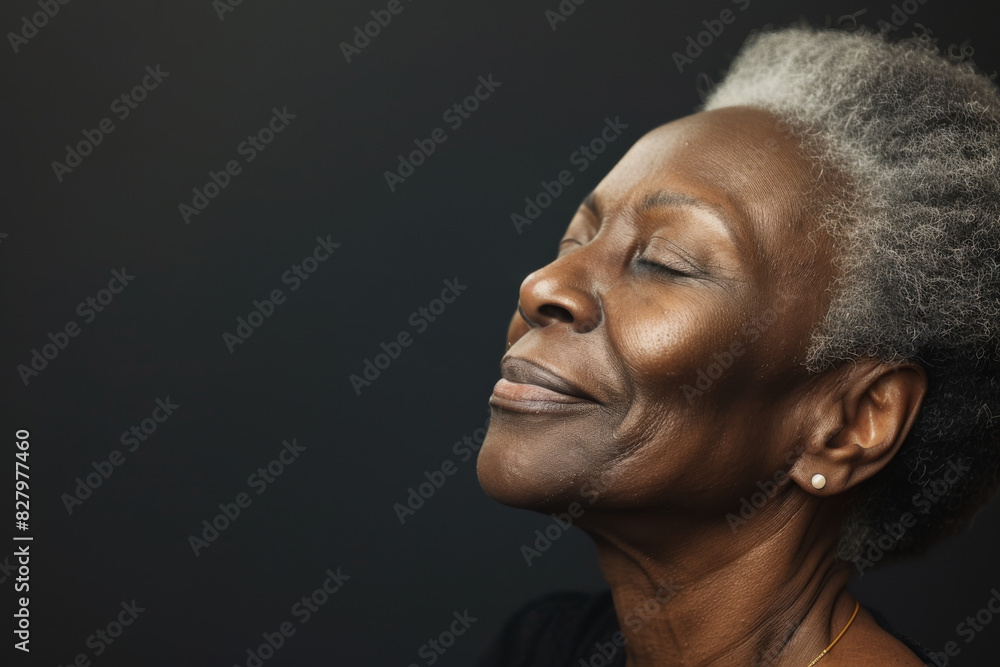 A close up of a black woman's face with her eyes closed looking to a side A close up of a black woman's face with her eyes closed looking to a side