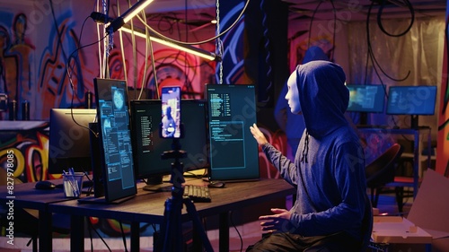 Fotografija Hackers concealing their identity filming ransom video in hidden underground bas