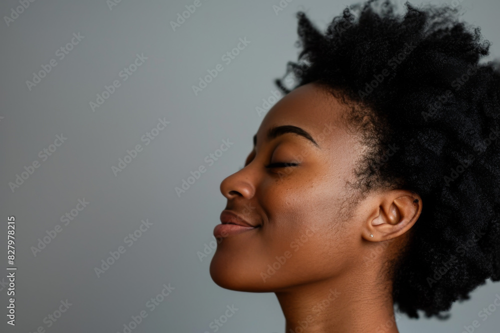 A close up of a black woman's face with her eyes closed looking to a side A close up of a black woman's face with her eyes closed looking to a side