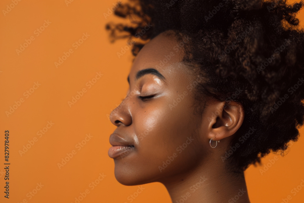 A close up of a black woman's face with her eyes closed looking to a side A close up of a black woman's face with her eyes closed looking to a side