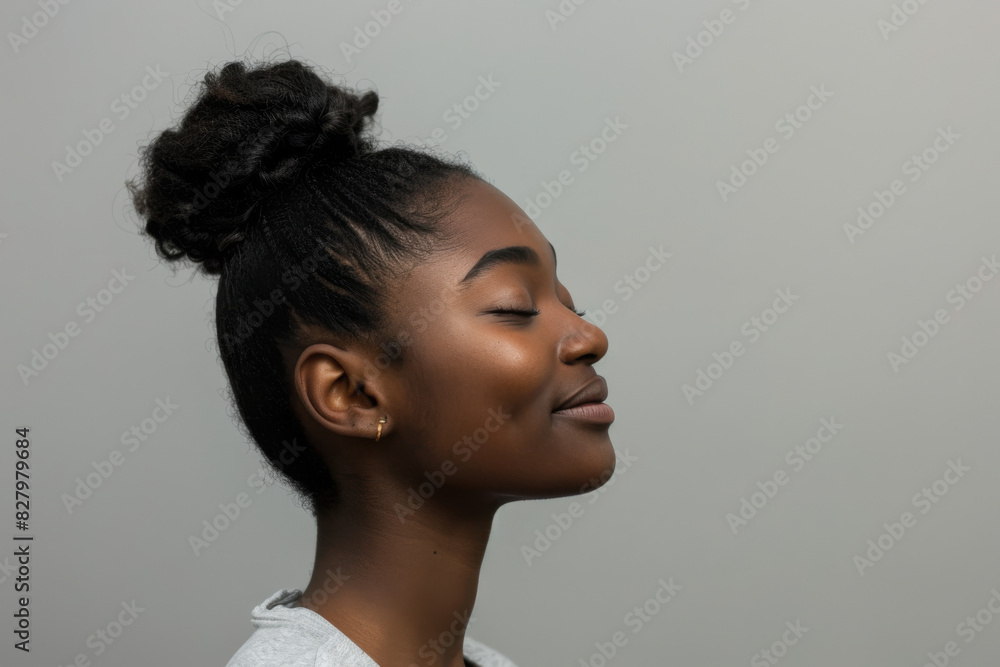 A close up of a black woman's face with her eyes closed looking to a side A close up of a black woman's face with her eyes closed looking to a side