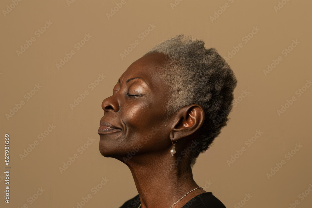 A close up of a black woman's face with her eyes closed looking to a side A close up of a black woman's face with her eyes closed looking to a side