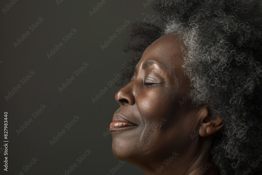 A close up of a black woman's face with her eyes closed looking to a side A close up of a black woman's face with her eyes closed looking to a side