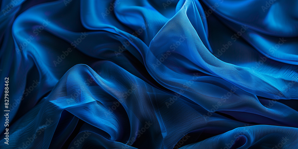 Blue fabric with delicate folds. Silk satin fabric backdrop with copy space. Blue fabric with delicate folds. Silk satin fabric backdrop with copy space.