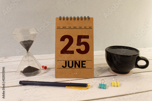 25 june wooden calendar in white background