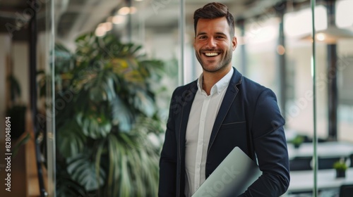 Wallpaper Mural Smiling man standing with his laptop in his arm. Torontodigital.ca