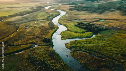 High-angle shot of a winding river cutting through a picturesque landscape.