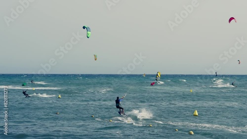 Group of people kite surfing in the ocean
