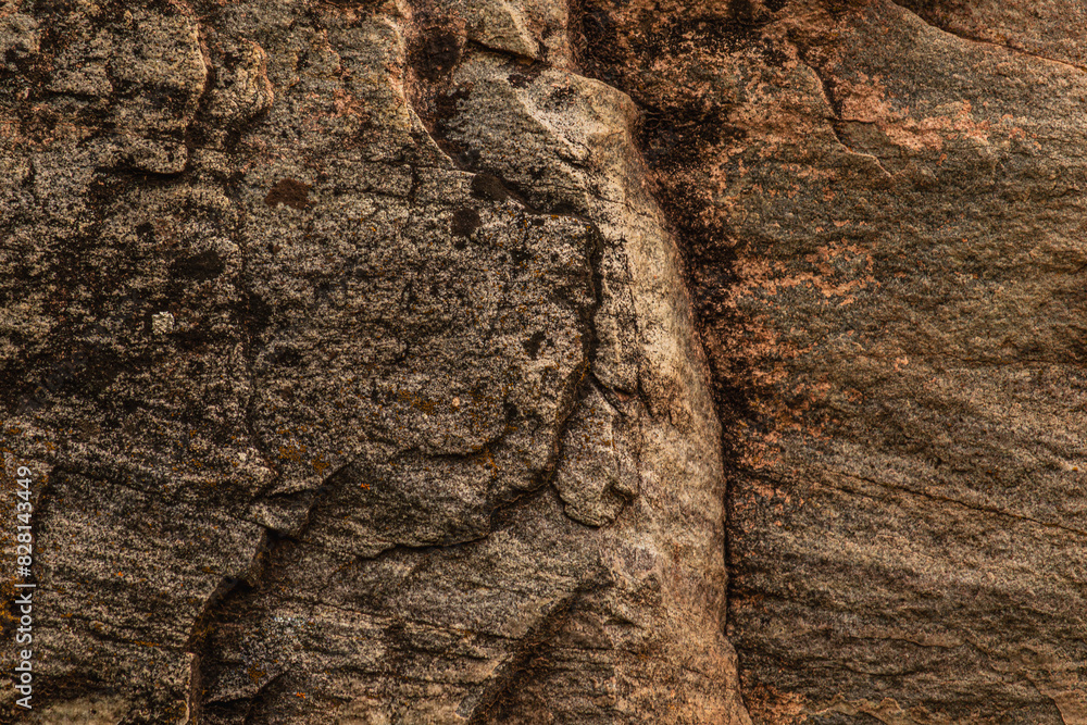 Dark red orange brown stone with cracks Closeup of uneven mountain surface Dark red orange brown stone with cracks Closeup of uneven mountain surface
