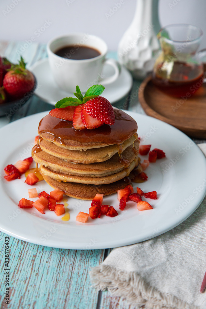 Stack of pancakes hotcakes with honey and strawberries breakfast food american style Stack of pancakes hotcakes with honey and strawberries breakfast food american style