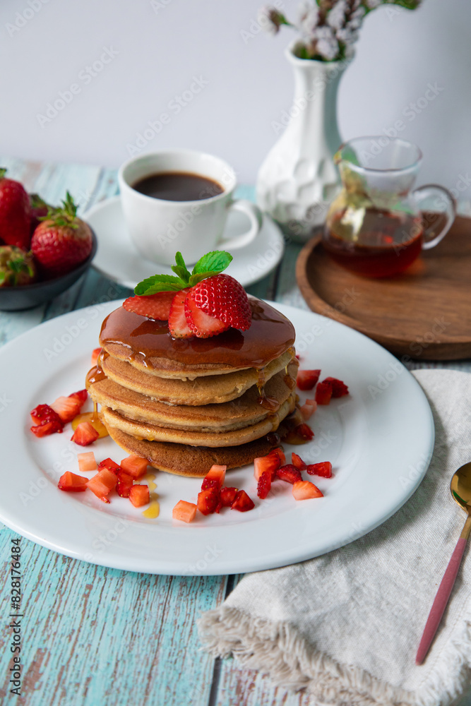 Stack of pancakes hotcakes with honey and strawberries breakfast food american style Stack of pancakes hotcakes with honey and strawberries breakfast food american style