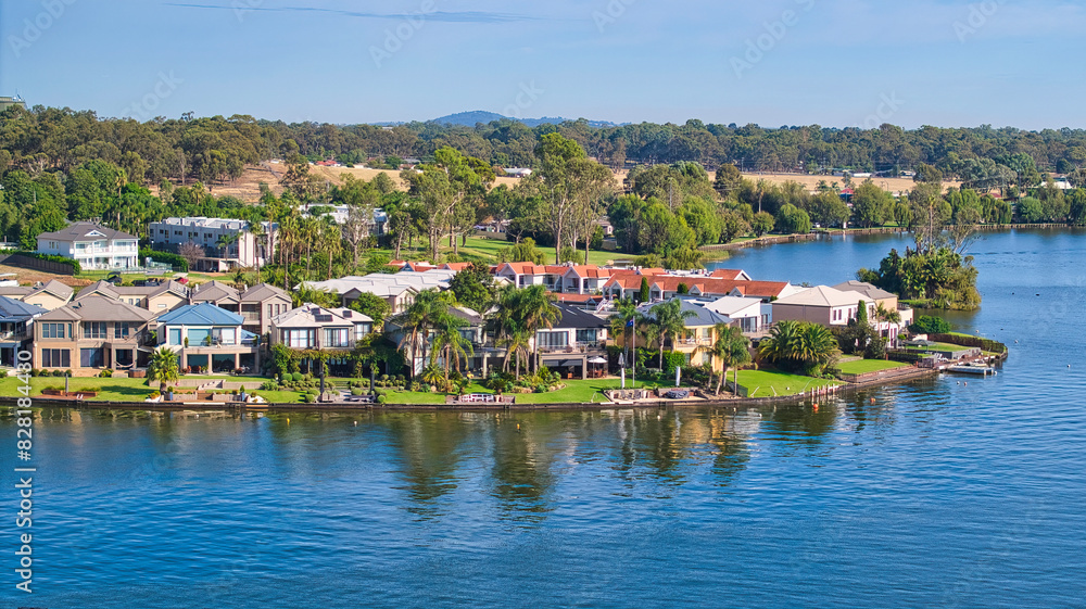 Large houses on the shore of Lake Mulwala with farmland and hills beyond Large houses on the shore of Lake Mulwala with farmland and hills beyond