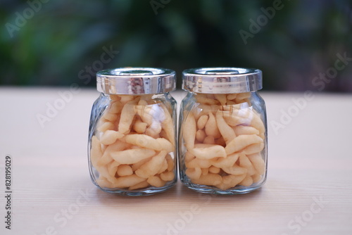 Two jars filled with telur gabus on a table photo