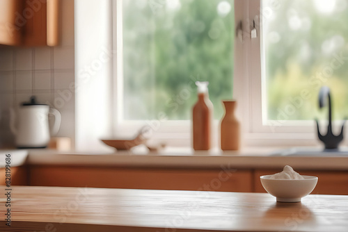 Empty wooden desk on blurred kitchen window for product presentation