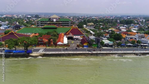 a city along the Tuban coast line in East Java, with houses lining the beach and boats bobbing in the ocean.