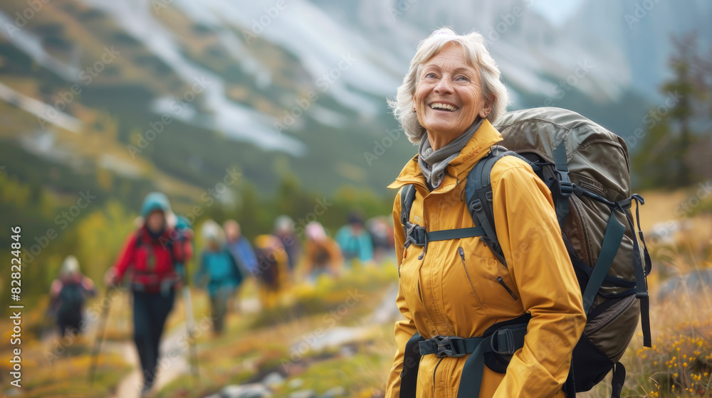 Happy elderly woman hiking with a group in mountains