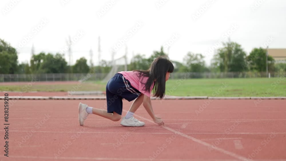 Handheld video Portrait of an Asian Thai kid girl, ages 8 to 10, exercising in an outdoor field. She likes to stretch and walk for exercise because it makes her body grow bright and strong. Handheld video Portrait of an Asian Thai kid girl, ages 8 to 10, exercising in an outdoor field. She likes to stretch and walk for exercise because it makes her body grow bright and strong.