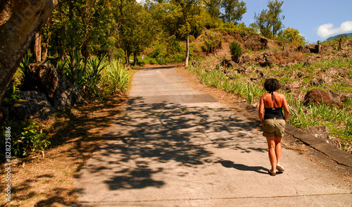  woman walks on a small road on Reunion Island