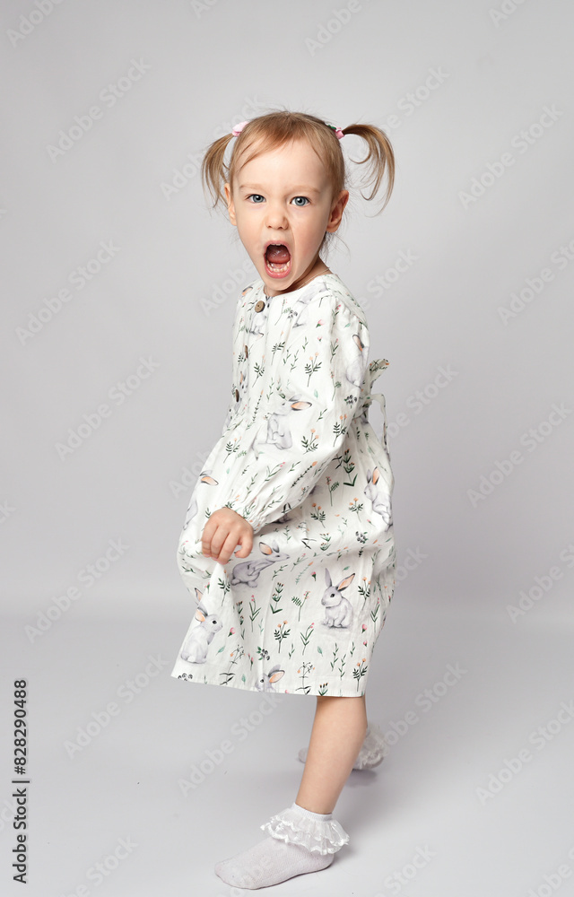 Studio shot of a little girl shouting with anger, standing on a white background Studio shot of a little girl shouting with anger, standing on a white background