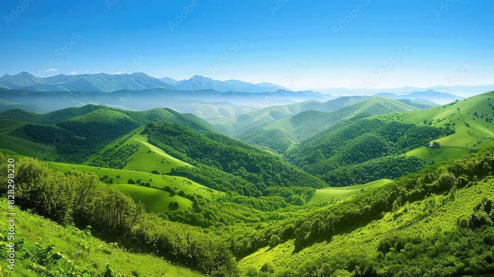 Obraz premium A picturesque landscape featuring rolling green mountains and valleys, with a backdrop of scattered clouds in a blue sky.