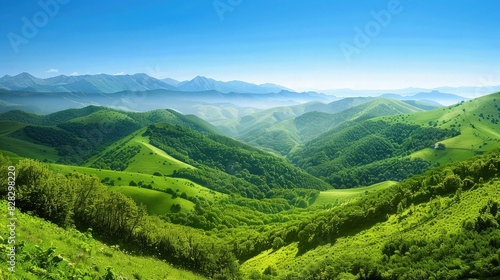 Wallpaper Mural A picturesque landscape featuring rolling green mountains and valleys, with a backdrop of scattered clouds in a blue sky. Torontodigital.ca