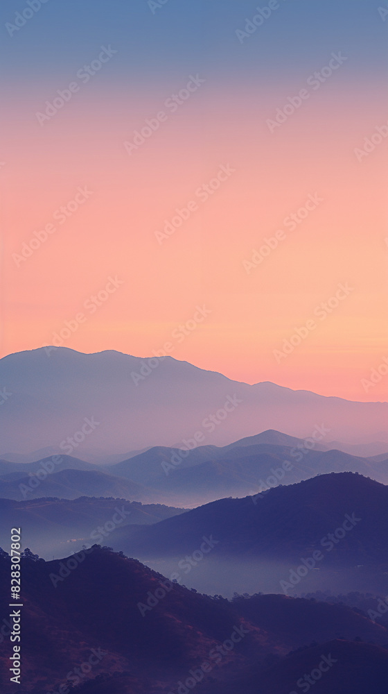 Serene mountain landscape at sunset with layers of mountains fading into the horizon under a colorful sky. Serene mountain landscape at sunset with layers of mountains fading into the horizon under a colorful sky.