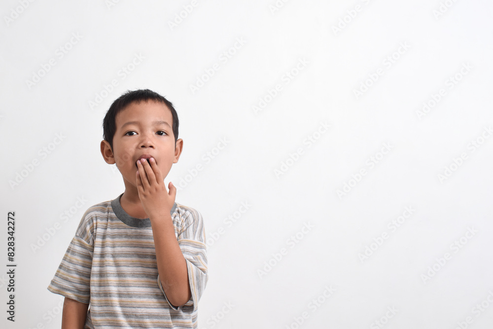 Image of Asian child posing covering his mouth with both hands on a white background. portrait of an Asian boy Image of Asian child posing covering his mouth with both hands on a white background. portrait of an Asian boy